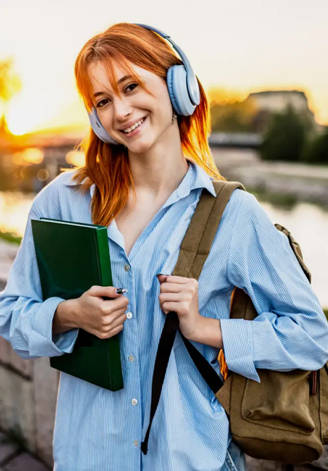 happy student posing in front of a lake