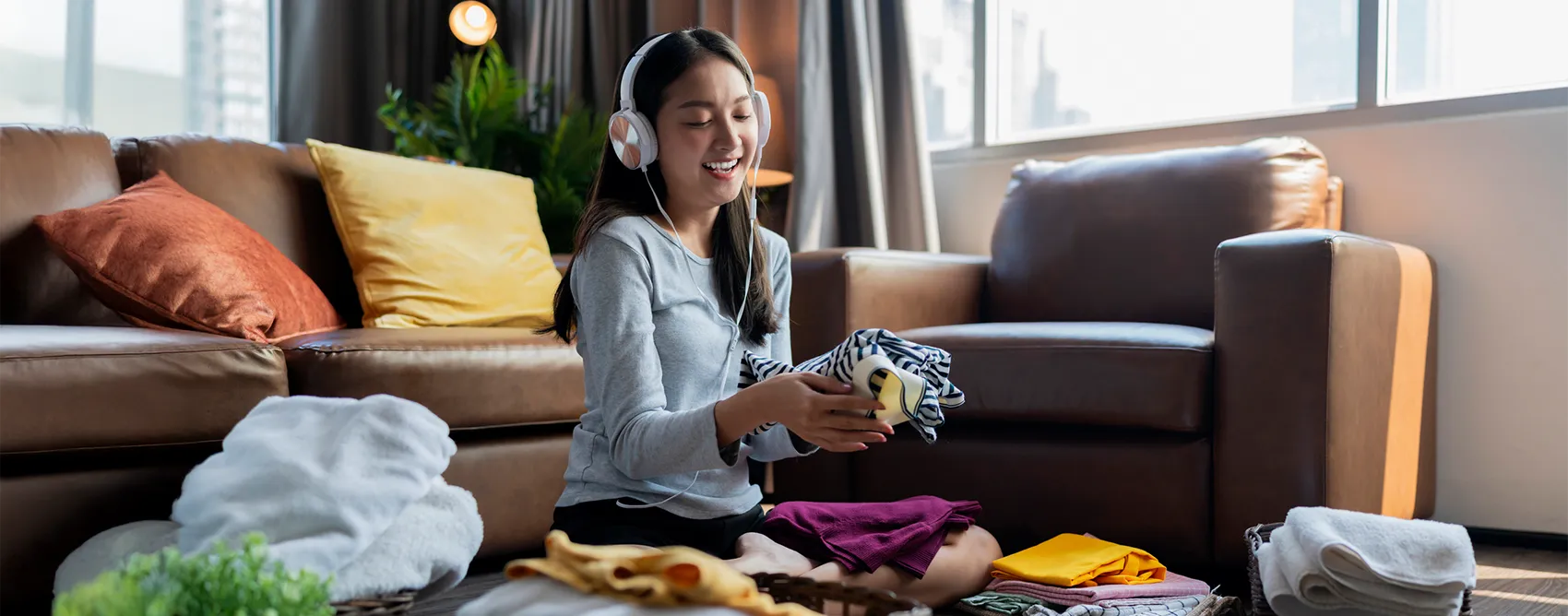 young woman folding laundry
